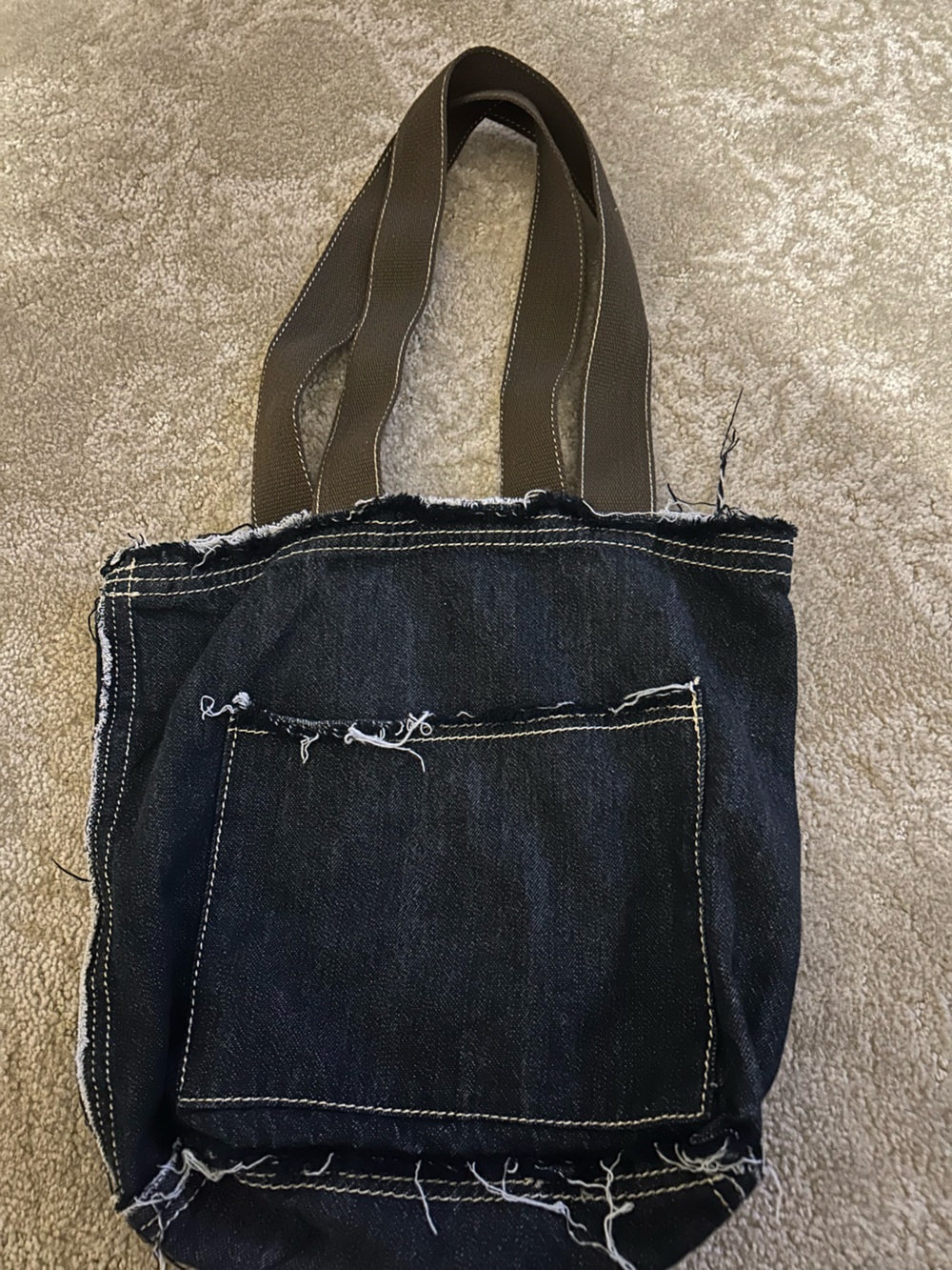 31 “Grunge” -like dark navy denim purse bag w/ brown double handles.